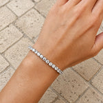 925 sterling silver tennis bracelet with round cubic zirconia stones worn on the wrist