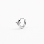 Rhodium-plated sterling silver flower huggie earring with clear cubic zirconia stones worn on the ear.