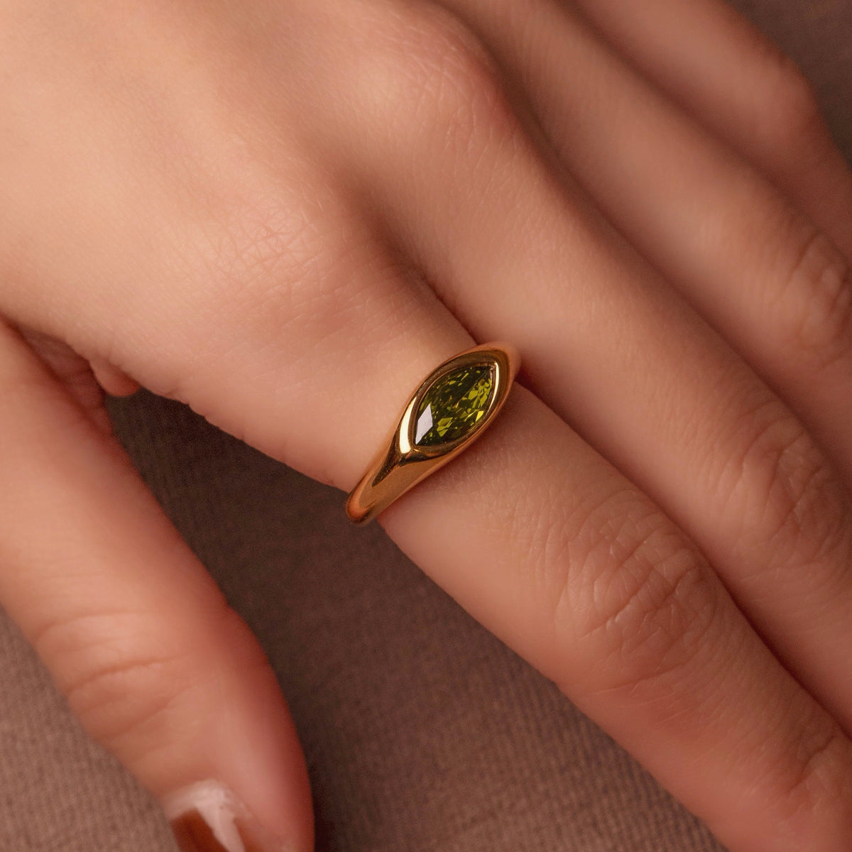 Gold-plated stainless steel ring with marquise-cut green cubic zirconia stone