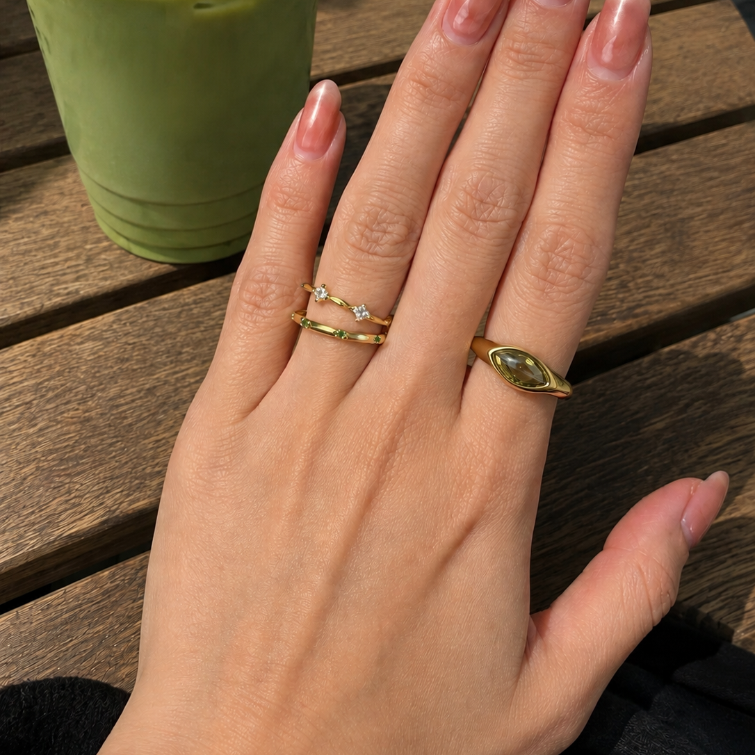 Gold-plated stainless steel ring with marquise-cut green cubic zirconia stone