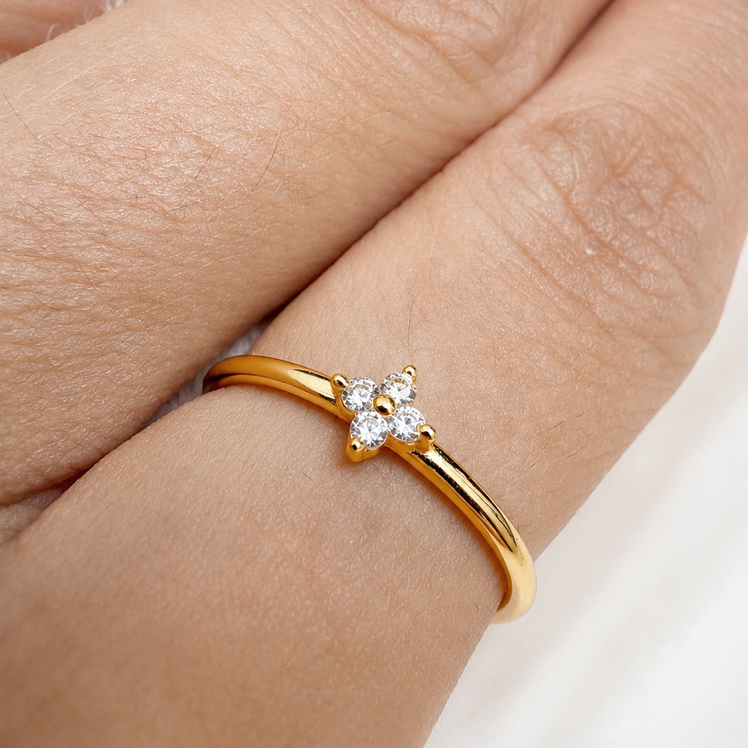 Gold-plated 925 sterling silver ring with delicate flower cubic zirconia detail worn on the finger