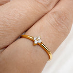 Gold-plated 925 sterling silver ring with delicate flower cubic zirconia detail worn on the finger