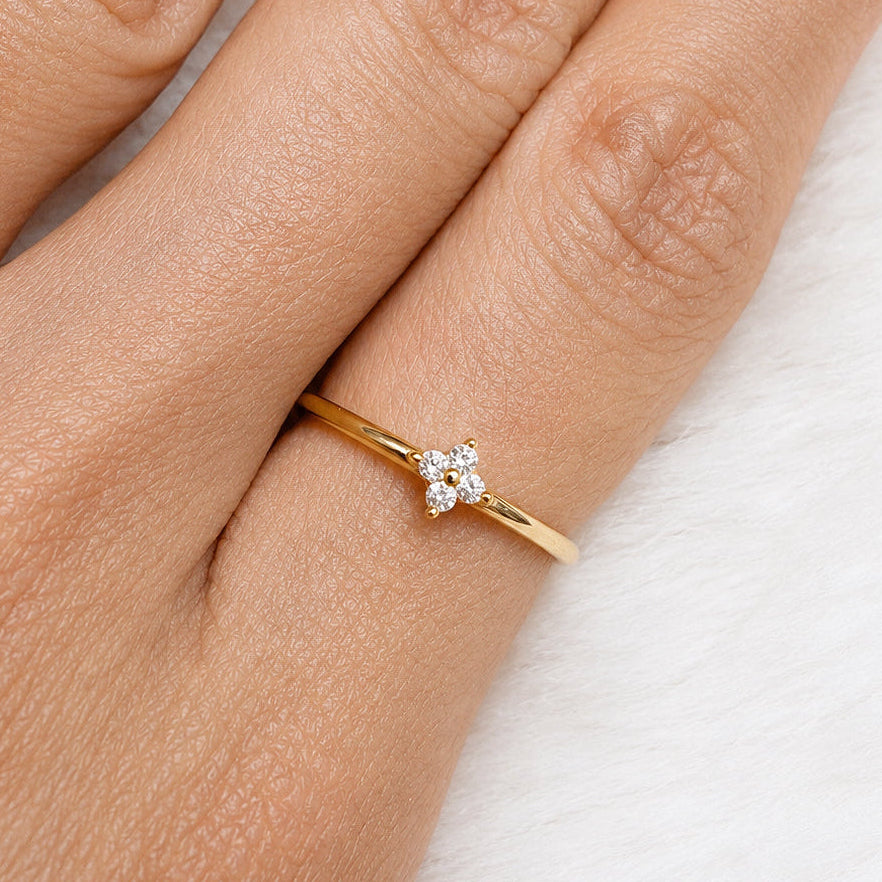 Gold-plated 925 sterling silver ring with delicate flower cubic zirconia detail worn on the finger