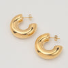 Gold-plated stainless steel chunky C-shaped hoop earrings with a smooth polished finish on a light background