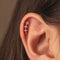 Gold-plated stainless steel floral ear stud with clear cubic zirconia stones and a round back worn on the upper ear
