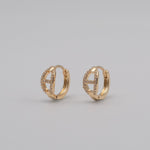 Gold-plated stainless steel huggie earrings with pavé cubic zirconia link details 
