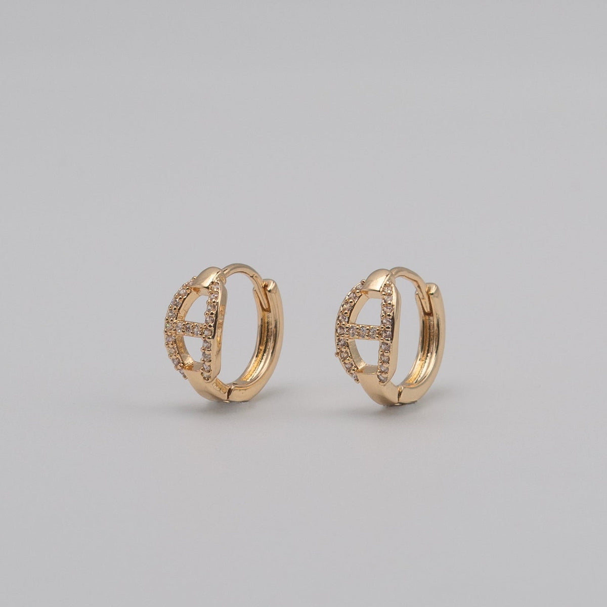 Gold-plated stainless steel huggie earrings with pavé cubic zirconia link details 