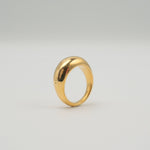 Gold-plated stainless steel smooth dome ring with a polished finish on a light background