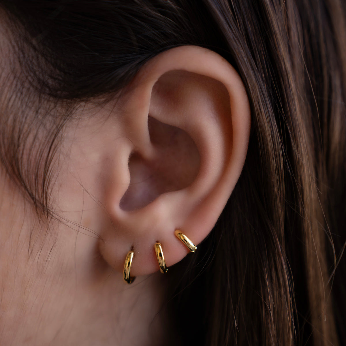 Gold-plated sterling silver classic huggie hoop earrings with a smooth polished finish