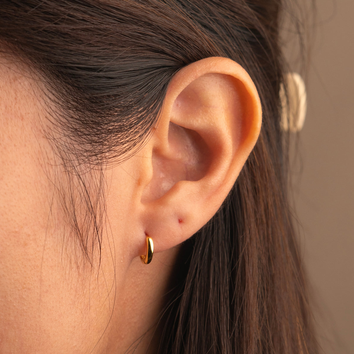 Gold-plated sterling silver classic huggie hoop earrings with a smooth polished finish