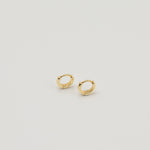 Gold-plated sterling silver classic huggie hoop earrings with a smooth polished finish on a light background