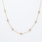 Gold-plated sterling silver station necklace with small clear cubic zirconia floral motifs 
