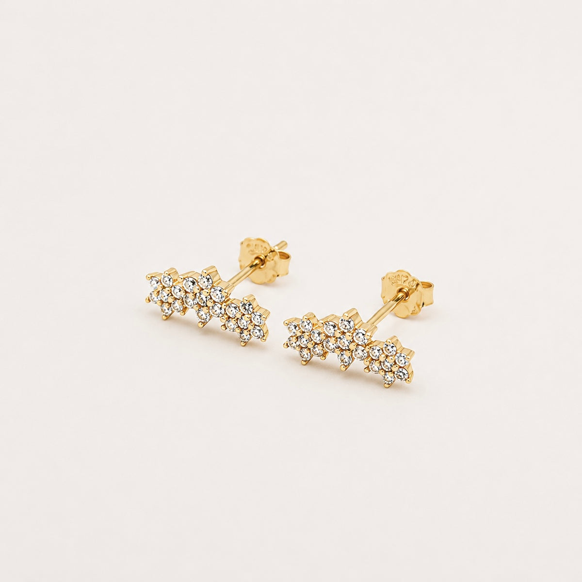 Gold-plated sterling silver stud earrings with clustered floral cubic zirconia details