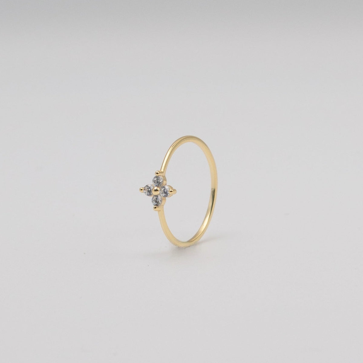 Gold-plated sterling silver flower ring with clear cubic zirconia stones .