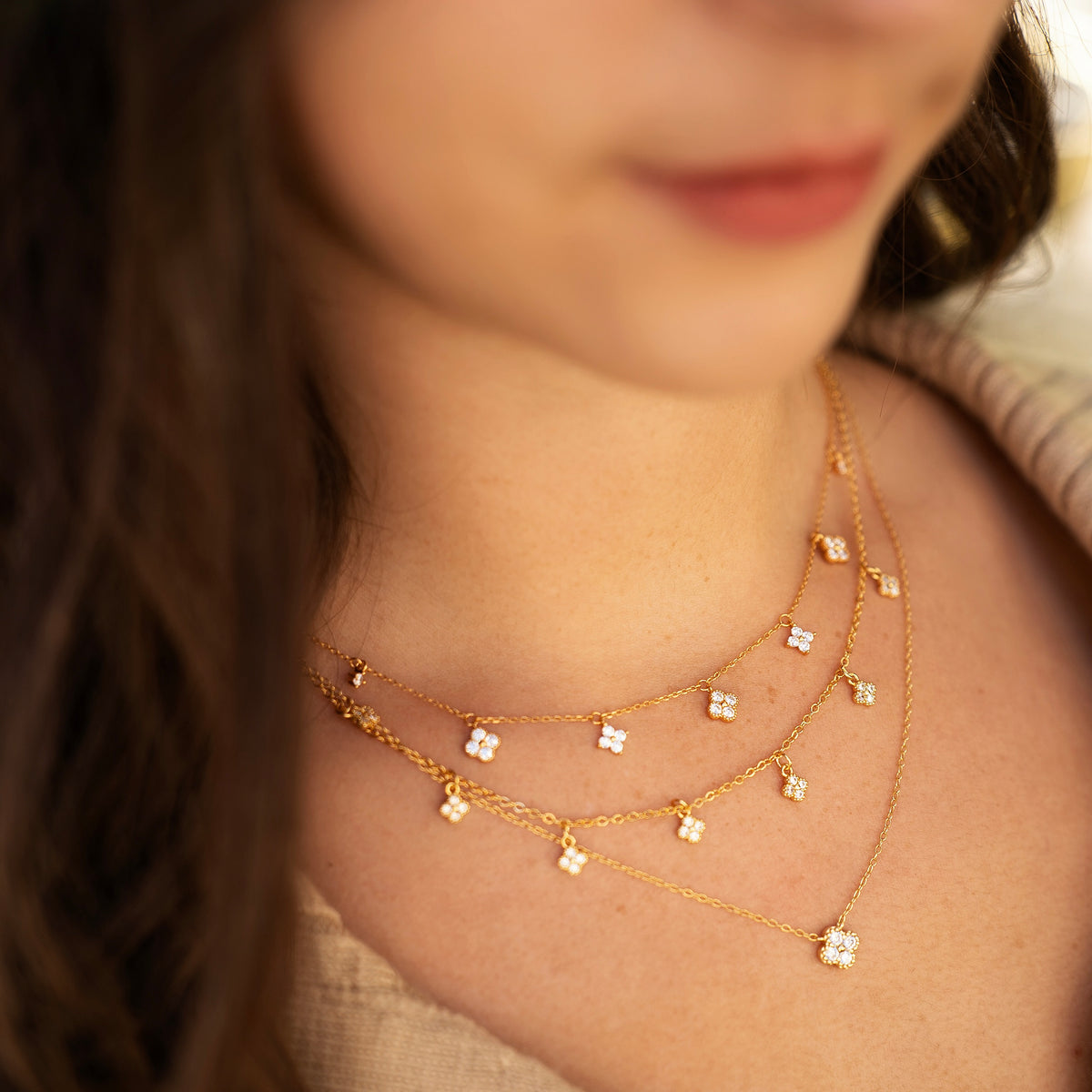 Gold-plated sterling silver necklace with a four-petal cubic zirconia pendant 