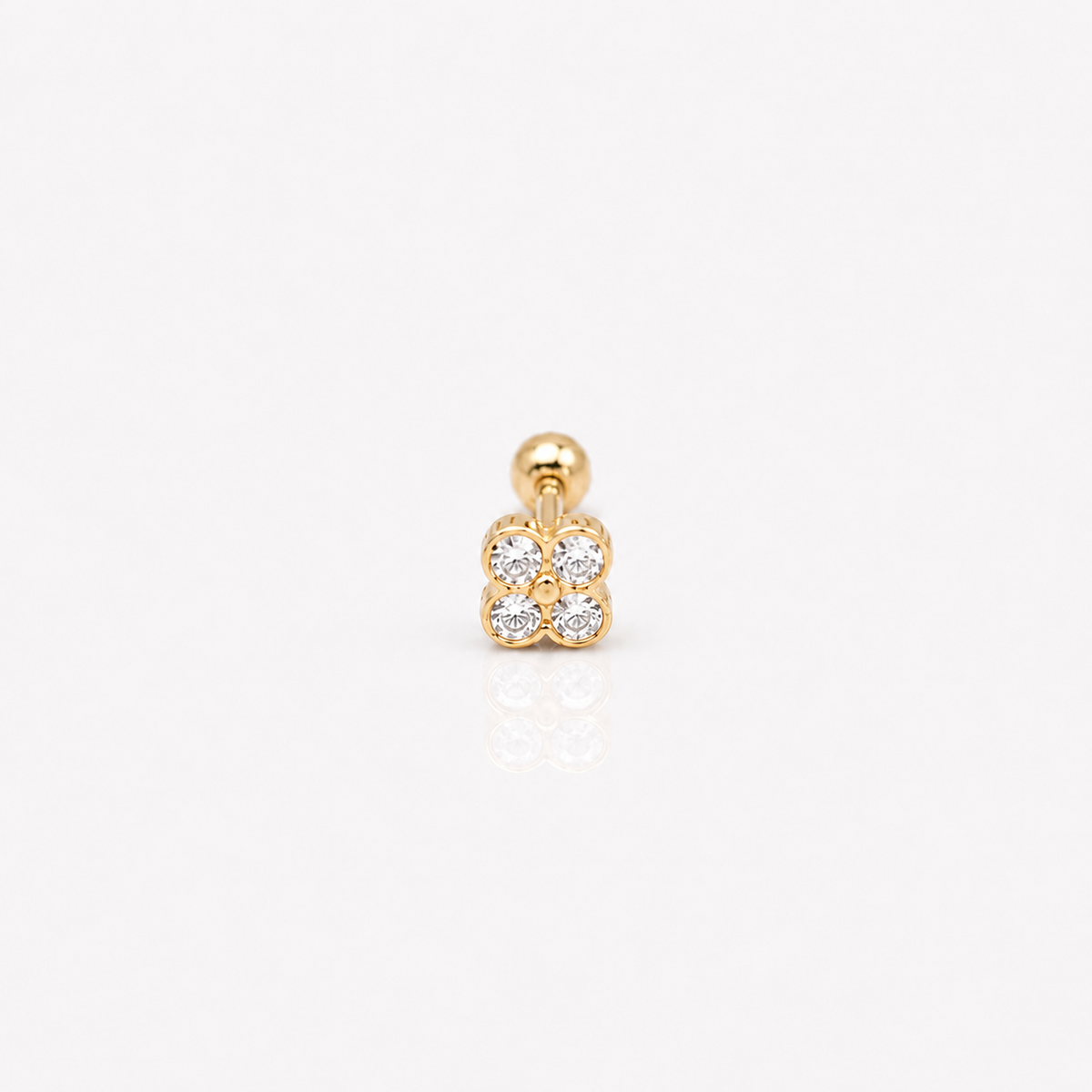Gold-plated sterling silver round-back stud earring with a four-petal clear cubic zirconia design on a white background