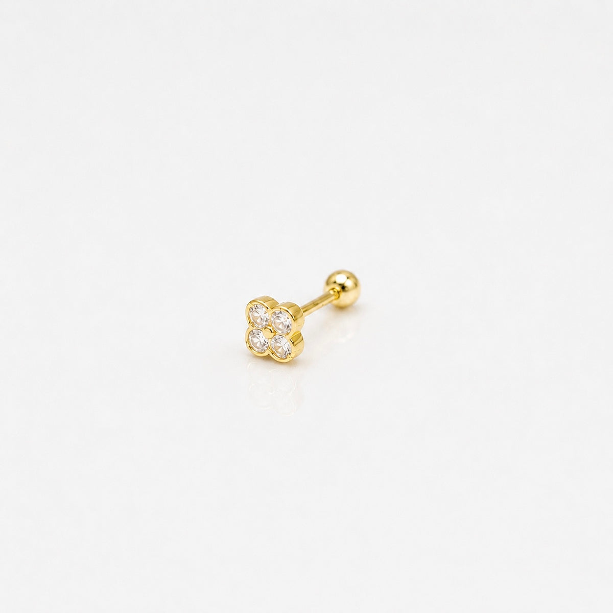 Gold-plated sterling silver round-back stud earring with a four-petal clear cubic zirconia design on a white background