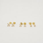 Gold-plated sterling silver stud earrings with four-petal clear cubic zirconia designs 