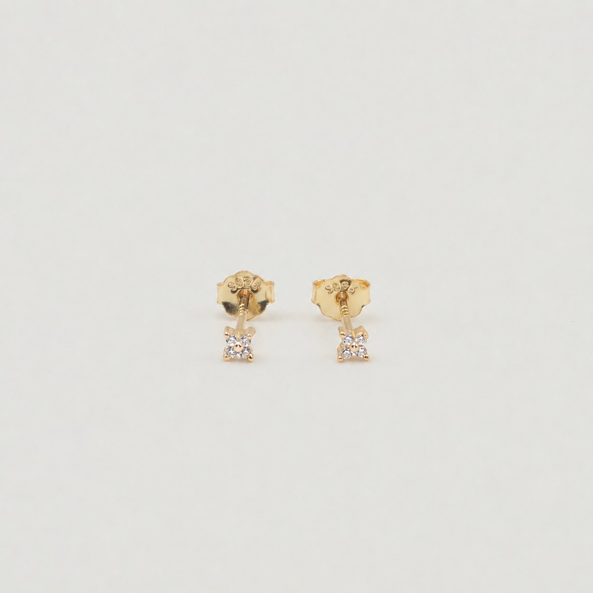 Gold-plated sterling silver stud earrings with four-petal clear cubic zirconia