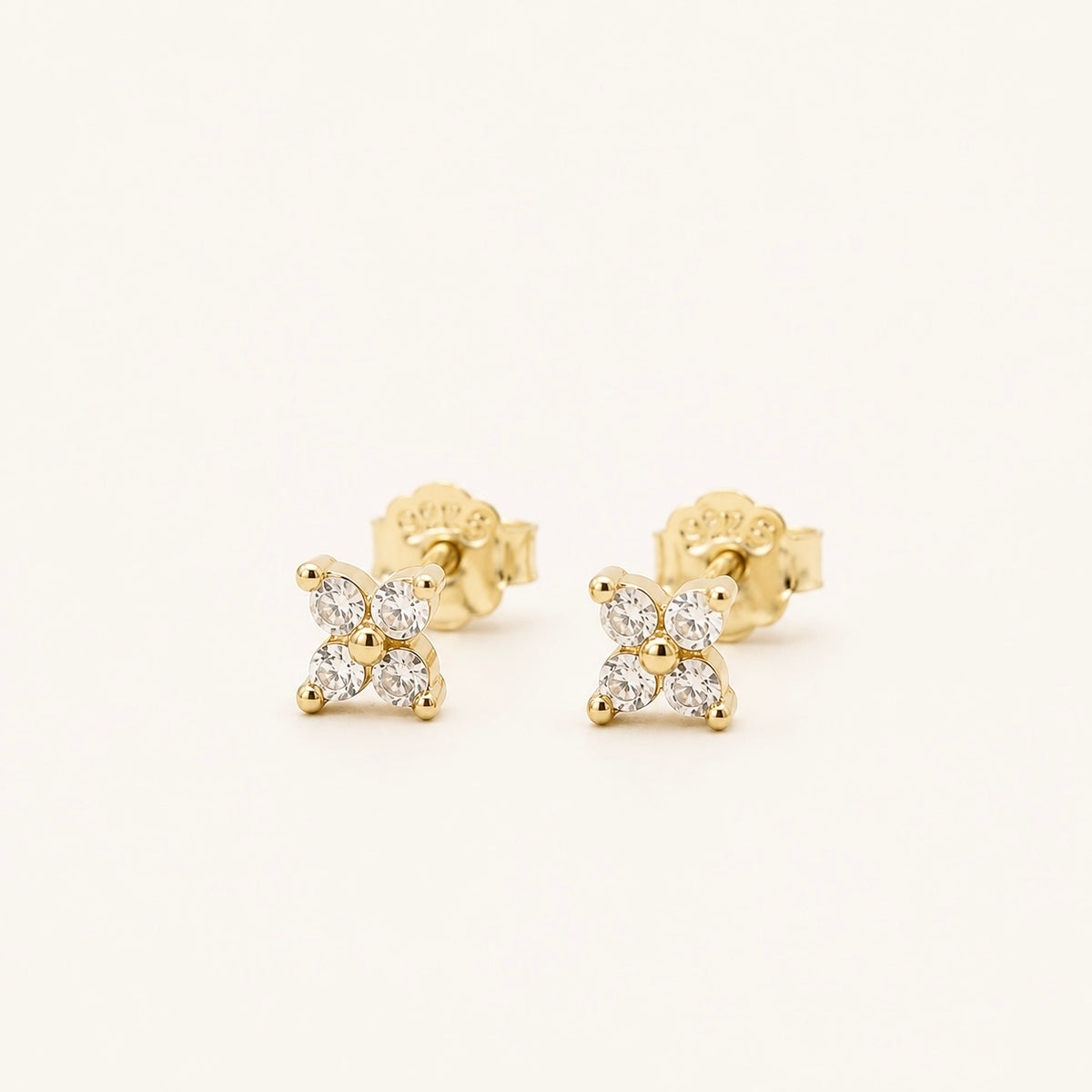 Gold-plated sterling silver stud earrings with four-petal clear cubic zirconia 