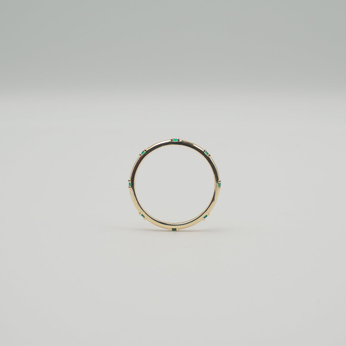 Gold-plated sterling silver delicate band ring with small green stones