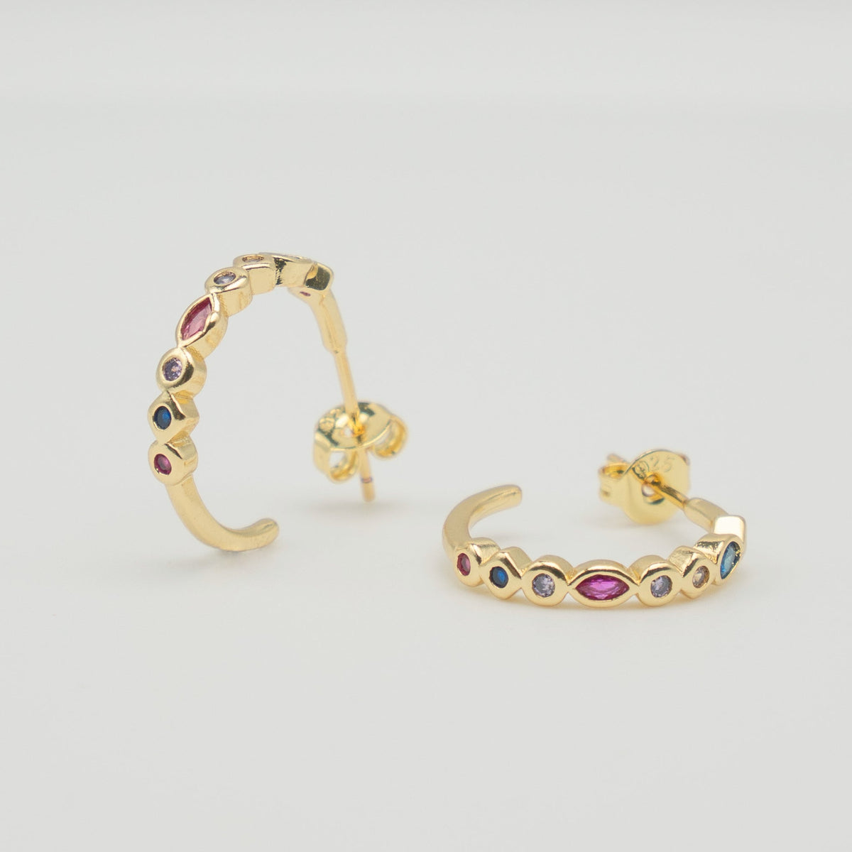 Gold-plated sterling silver hoop earrings with multicolor marquise and round cubic zirconia stones on a light background