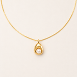 Gold-plated sterling silver necklace with a sculptural pendant featuring a natural pearl