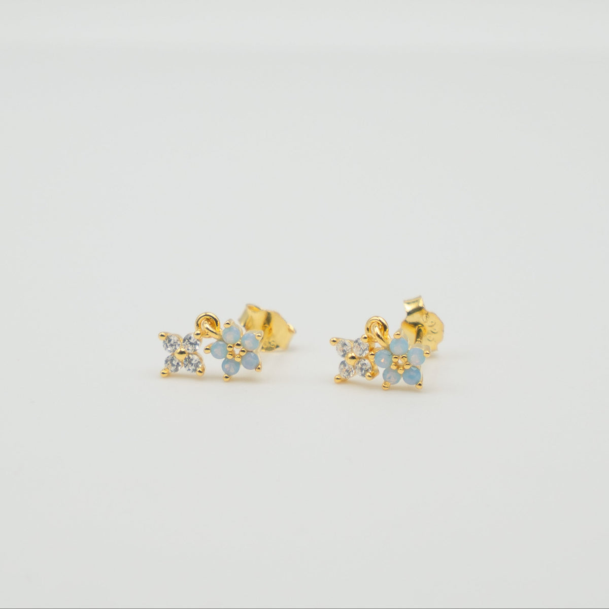 Gold-plated sterling silver stud earrings with opal flower details and clear cubic zirconia 