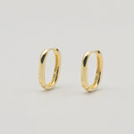 Gold-plated sterling silver oval hoop earrings with a smooth polished finish on a light background