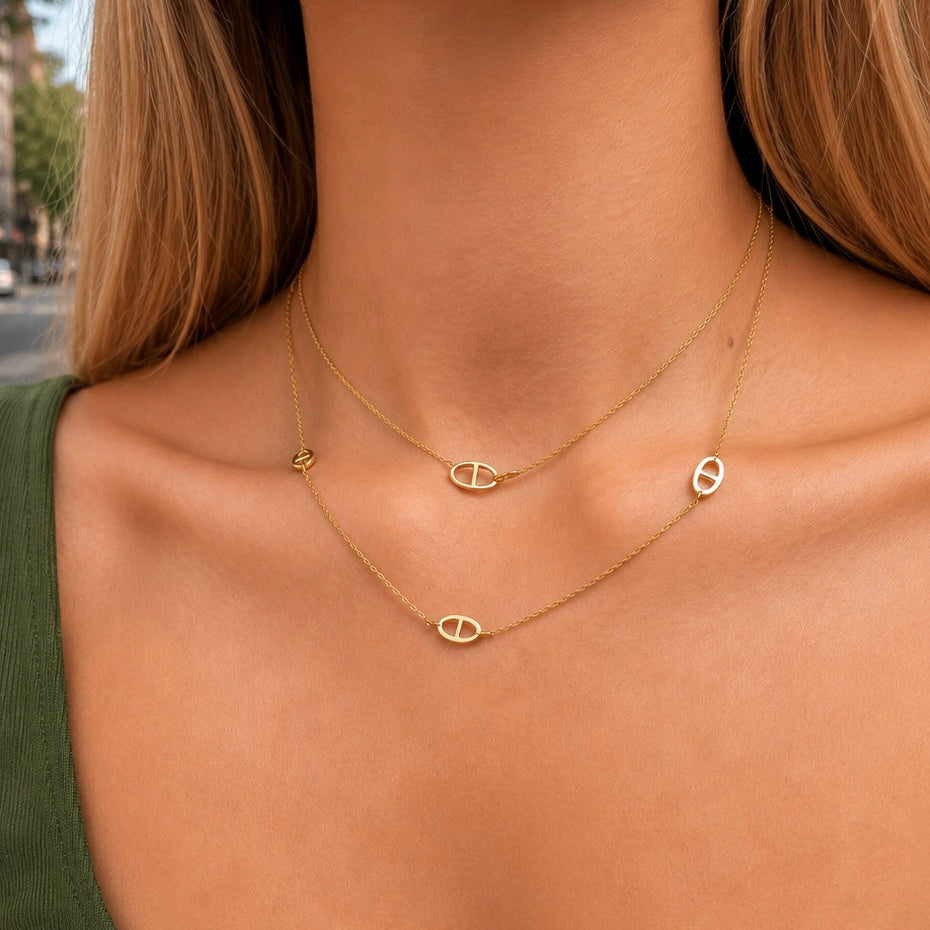 Gold-plated sterling silver station necklace with repeating oval link details worn around the neck
