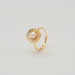 Gold-plated sterling silver ring with a central pearl surrounded by clear cubic zirconia details