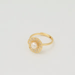 Gold-plated sterling silver ring with a central pearl surrounded by clear cubic zirconia details