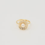 Gold-plated sterling silver ring with a central pearl surrounded by clear cubic zirconia details