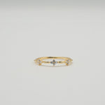 Gold-plated sterling silver ring with three small clover-shaped clear cubic zirconia details worn on the finger