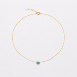 Gold-plated sterling silver necklace with a small turquoise-blue flower pendant on a delicate chain