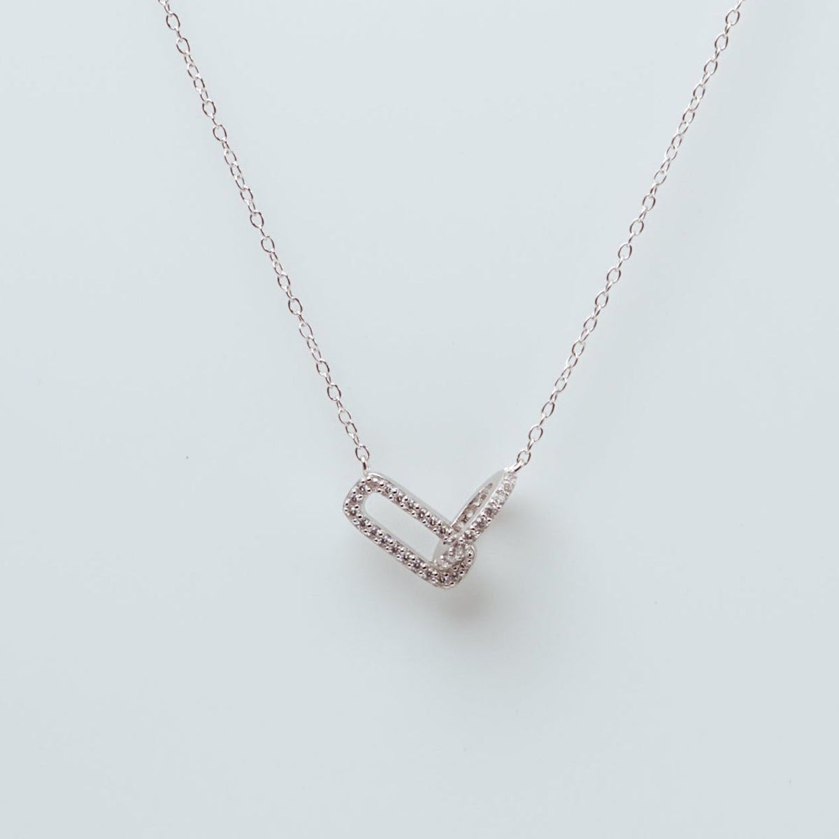 Rhodium-plated sterling silver necklace with interlocking double heart pendant and cubic zirconia stones