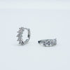 Rhodium-plated 925 sterling silver huggie earrings with floral cubic zirconia details