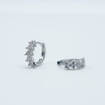 Rhodium-plated 925 sterling silver huggie earrings with floral cubic zirconia details