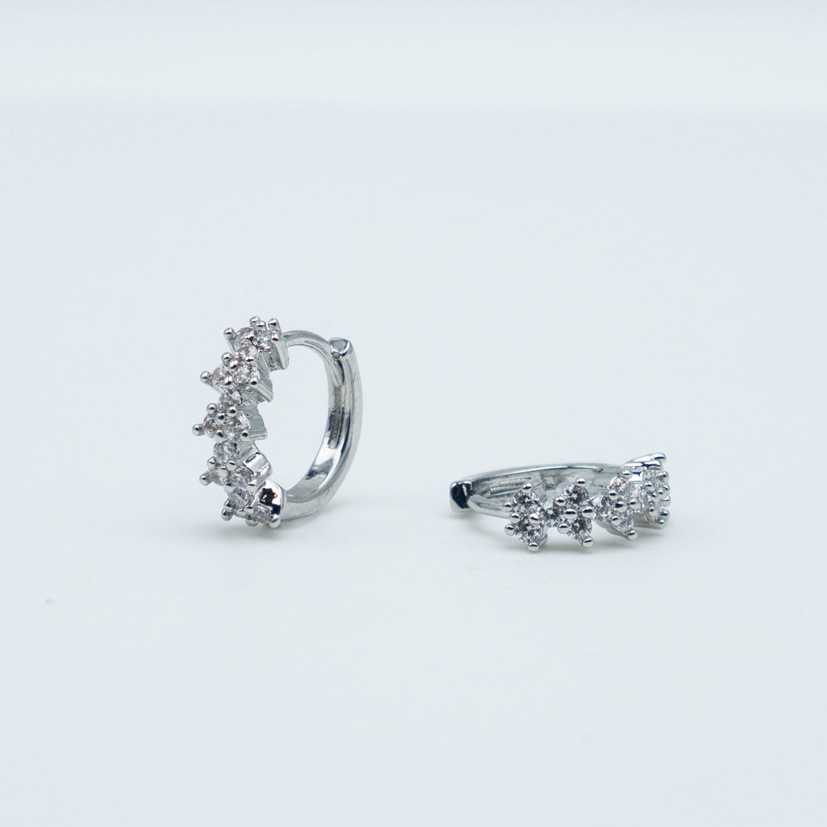 Rhodium-plated 925 sterling silver huggie earrings with floral cubic zirconia details