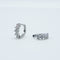 Rhodium-plated 925 sterling silver huggie earrings with floral cubic zirconia details