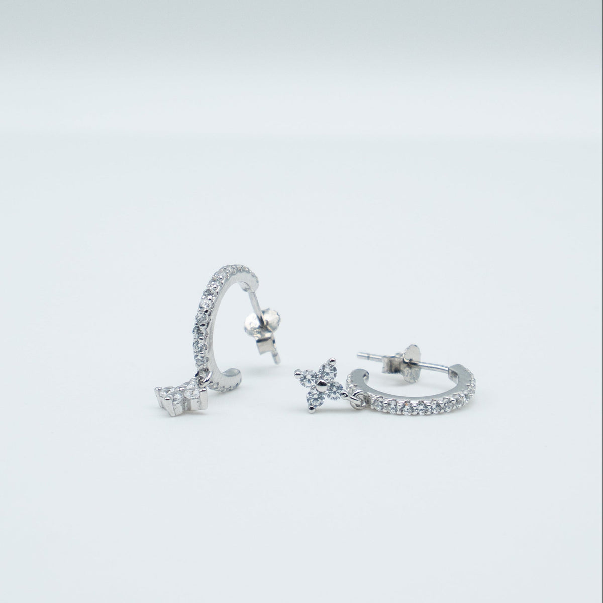 Rhodium-plated 925 sterling silver pavé hoop earrings with flower cubic zirconia charms
