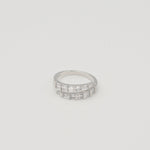 Rhodium-plated sterling silver band ring with two rows of baguette-cut clear cubic zirconia stones on a light background