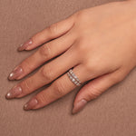 Rhodium-plated sterling silver band ring with two rows of baguette-cut clear cubic zirconia stones worn on finger