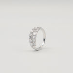 Rhodium-plated sterling silver band ring with two rows of baguette-cut clear cubic zirconia stones on a light background
