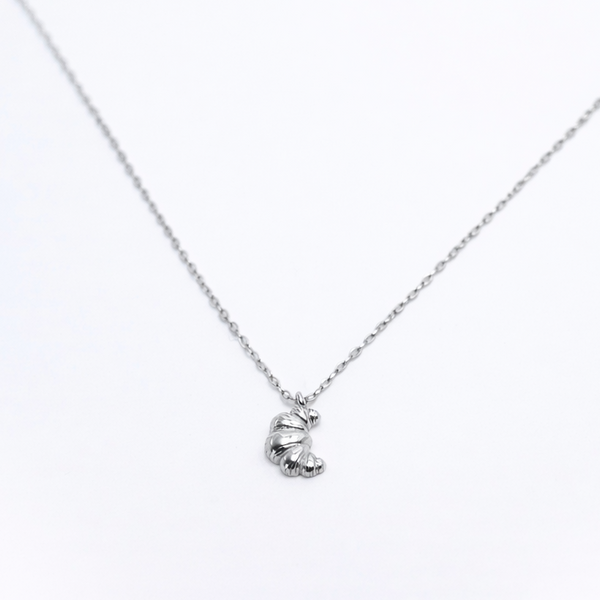 Rhodium-plated sterling silver necklace with a small croissant pendant on a white background