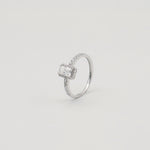 Rhodium-plated sterling silver solitaire ring with a cushion-cut moissanite center stone and pavé band 