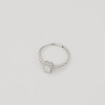Rhodium-plated sterling silver solitaire ring with a cushion-cut moissanite center stone and pavé band