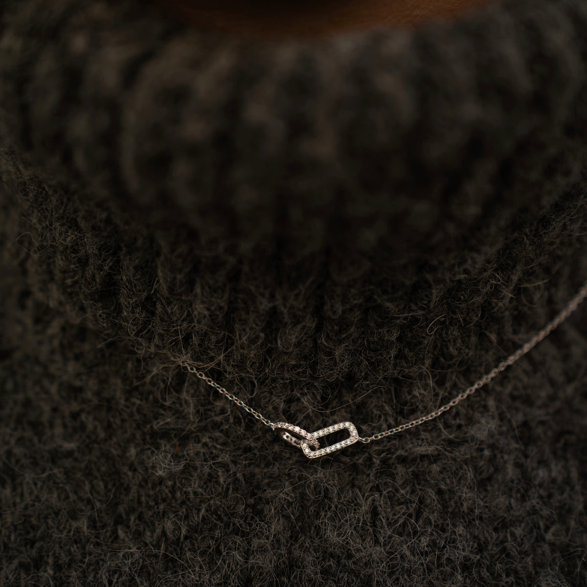 Rhodium-plated sterling silver necklace with interlocking double heart pendant and cubic zirconia stones