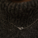 Rhodium-plated sterling silver necklace with interlocking double heart pendant and cubic zirconia stones