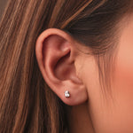 Rhodium-plated sterling silver stud earrings with emerald-cut clear cubic zirconia stones